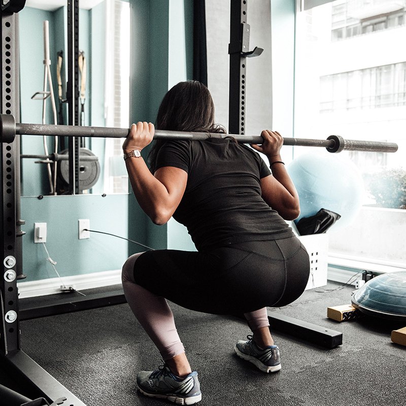 Mujer entrenando con barra